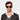 Man wearing TBD Eyewear's Palm Eco sunglasses in Spotted Havana with Bottle Green lenses a timeless expression of Italian design