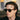 Man with Donegal Earth sunglasses in environmentally conscious, featuring bio grey lenses by Tbd Eyewear