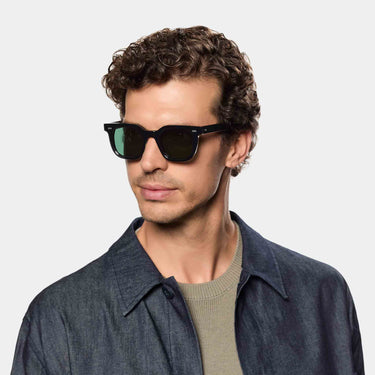 Man wearing Mastro Eco Black sunglasses by TBD Eyewear – featuring a sustainable frame and Bottle Green lenses made in Italy