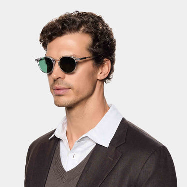 Man wearing Cran sunglasses in Eco Transparent Bottle Green bio-acetate frame sustainably handcrafted in Italy TBD Eyewear