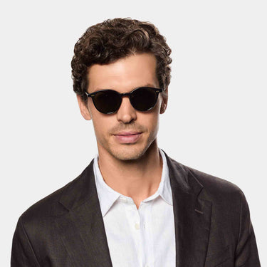 Man wearing Cran sunglasses by TBD Eyewear in Eco Black Gradient Grey sustainable bio-acetate handcrafted in Italy