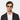 Man wearing Cran sunglasses by TBD Eyewear in Honey frame and blue lenses, crafted from bio-acetate and made in Italy