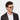 A smiling man wearing Cran sunglasses by TBD Eyewear in Honey frame and blue lenses in bio-acetate materials and made in Italy