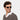 A smiling man wearing Lapel sunglasses in Transparent Gradient Grey bio-acetate frame handcrafted in Italy by TBD Eyewear