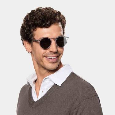 A smiling man wearing Lapel sunglasses in Transparent Gradient Grey bio-acetate frame handcrafted in Italy by TBD Eyewear