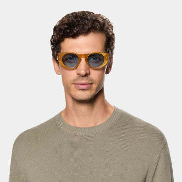 Man wearing sunglasses madras eco honey blue lenses and sustainable materials  tbd eyewear made in Italy