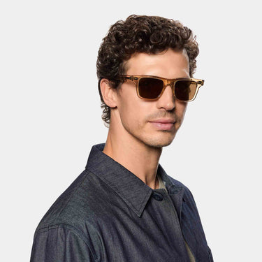 A man wearing sunglasses denim eco champagne tobacco sustainable tbd eyewear made in Italy