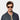 A man wearing sunglasses denim eco champagne tobacco sustainable tbd eyewear handcrafted in Italy