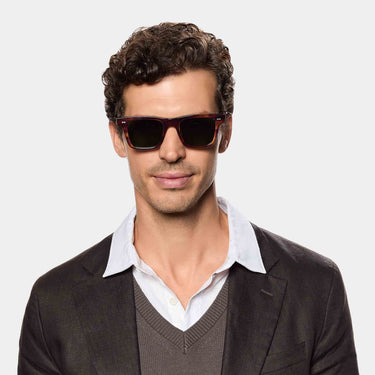 Man wearing TBD Eyewear's Denim Eco sunglasses handcrafted in Italy with a sustainable Havana bio-acetate and Bottle Green lenses