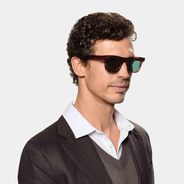 Man wearing TBD Eyewear's Denim Eco sunglasses made in Italy with a sustainable Havana bio-acetate and Bottle Green lenses