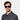 A man wearing sunglasses denim eco black gradient grey sustainable tbd eyewear front hmade in Italy
