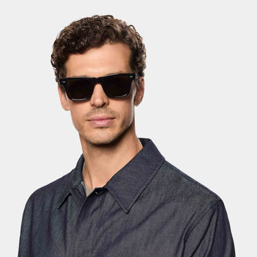 A man wearing sunglasses denim eco black gradient grey sustainable tbd eyewear front hmade in Italy