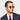 Male model with an oval face shape wearing the Hem Eco Golden Havana Bottle Green Tailored Edition sunglasses in a three-quarter pose, highlighting the frame’s classic round silhouette and refined sartorial details.