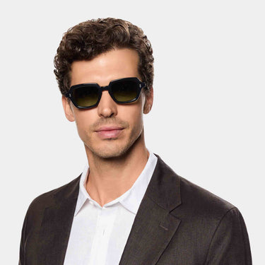 Man wearing Oak Black Green Sunglasses by TBD Eyewear blends classic design with modern character. Sustainably and handcrafted in Italy.