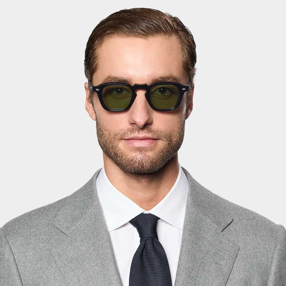 Side detail of Ply Black sunglasses by TBD Eyewear. Sustainable acetate renew frame with refined temples and green lenses, handcrafted in Italy.