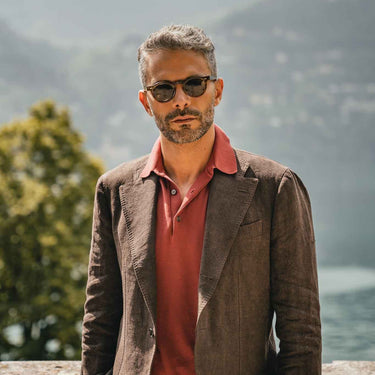 A man showcasing Welt Earth Bio sunglasses in environmentally conscious, featuring bottle green lenses by Tbd Eyewear
