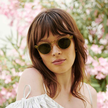 Woman wearing Sunglasses Welt Eco Champagne with Bottle Green lenses