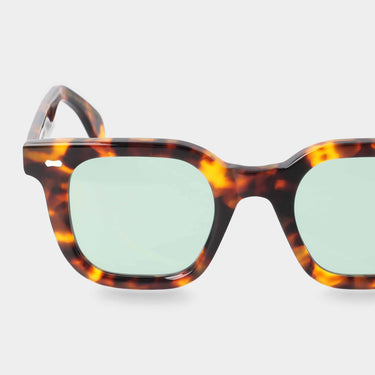 The Mastro Eco Spotted Havana sunglasses by TBD Eyewear are fully sustainable and handmade in Italy with a refined design and light green lenses.