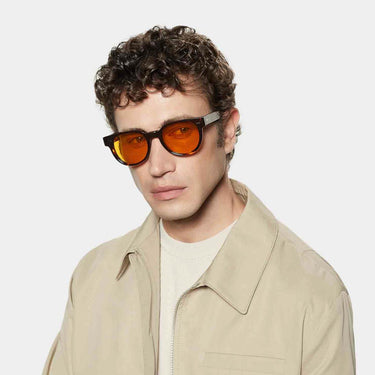 Round tortoise sunglasses with orange lenses: Palm TBD Eyewear